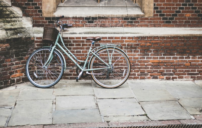 A bike leaning against a wall in Cambridge